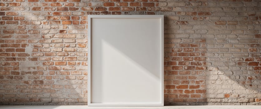 Rustic brick wall with large white frame for design presentation. photo