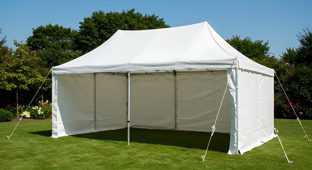 A tent with a white canopy on a lawn photo