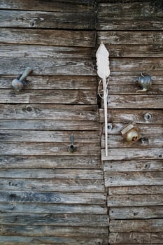 Small teapot, a turk, a jug and a hand grinder for coffee hang on an antique wooden door photo