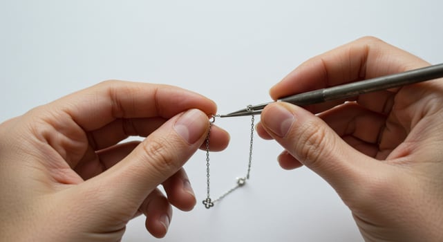 Person working on silver chain creation photo