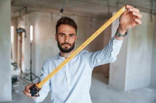 Holding ruler measurement, tool. The man is making repairs in the apartment photo