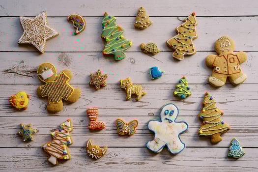 Christmas cookies with colorful icing lie on a light wooden table photo