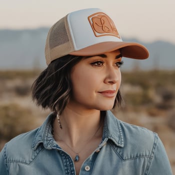 A woman wearing a hat in the desert photo