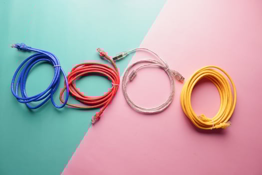 Colorful network and charging cables arranged on a pastel background photo