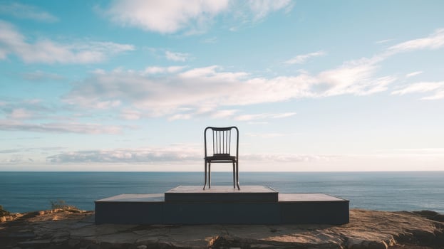 A chair sitting on top of a rock overlooking the ocean photo