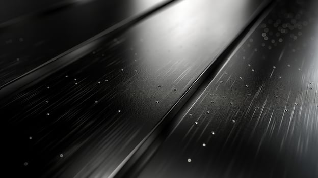 Abstract close-up of polished black surface with subtle textures and light reflections. photo