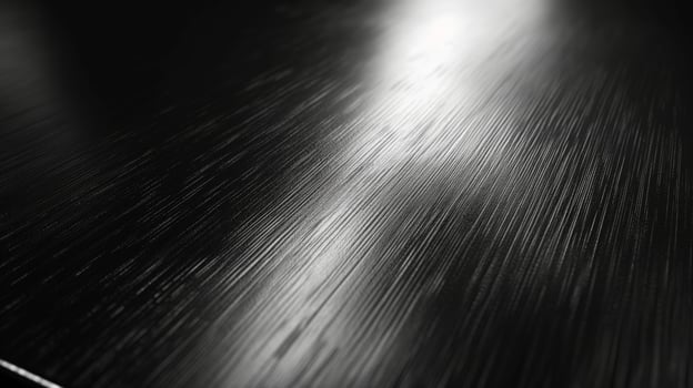 Close-up view of a sleek, polished black surface with subtle texture and reflections. photo