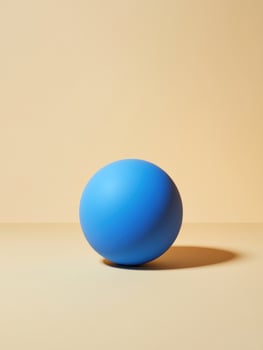 Minimalist composition with a single blue sphere on beige background photo