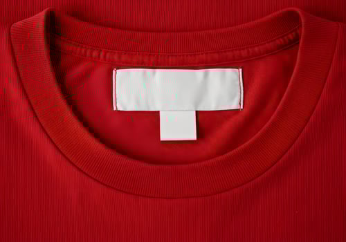 A red t - shirt with a white label on the back photo