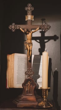 Jesus on the cross with bible and candle photo