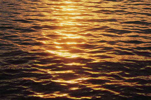 Sunlight Reflecting on Water Surface Creating Beautiful Golden Shimmer Effect photo