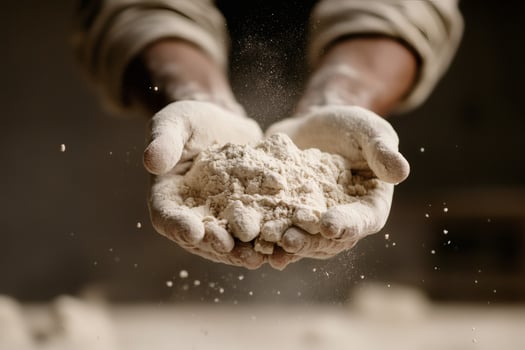 Hands Full of Flour Showcasing the Art of Baking in a Rustic Kitchen. photo