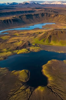 Aerial View of Icelandic Highlands with Lakes and Snowcapped Mountains photo