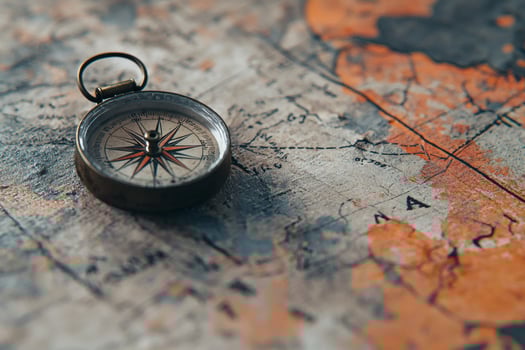 Old compass resting on worn map of the world photo