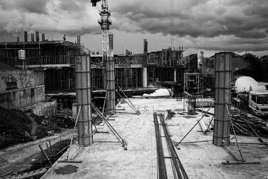 Construction Site with Crane and Concrete Pillars photo