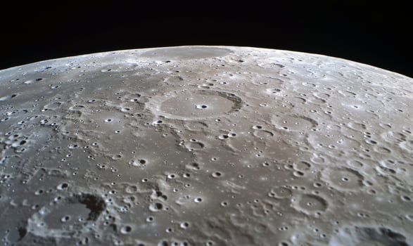 The moon's surface is shown from above photo