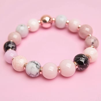 The pink and black bracelet is made with marble and glass beads photo
