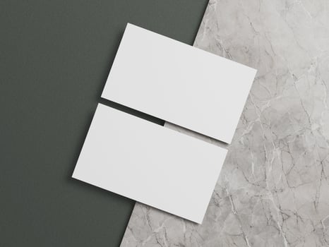 Business card mockup with white cards aligned on a gray marble background and dark green section. photo