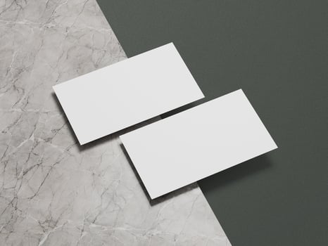 High-quality business card mockup featuring white cards placed on a marble and green textured backdrop. photo
