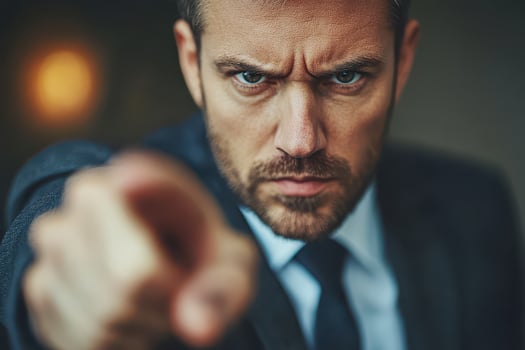 A man in a suit pointing at something photo
