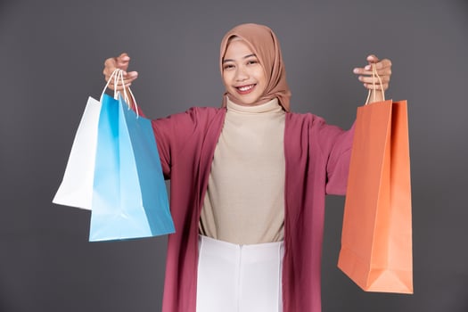 Hijab Female Carrying a Shopping Bag Isolated Background photo