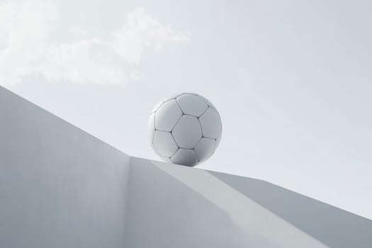 Soccer Ball Resting on White Structure Against Sky Minimalist Composition photo