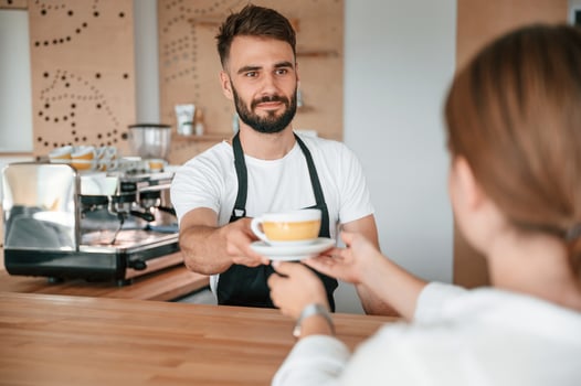 Customer takes her order from barista in the cafe. photo