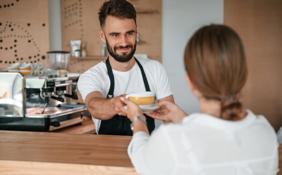 Customer takes ,her order from barista in the cafe photo
