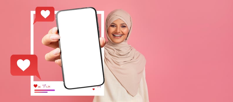 An influencer smiles while holding a smartphone with a blank screen, ready for social media engagement. Chat bubbles and heart icons enhance the digital atmosphere of connection. photo