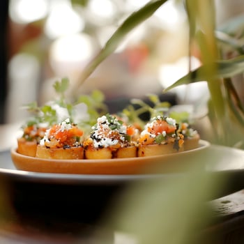 Canape with salmon, cheese and sesame seeds on a plate in a restaurant. selective focus. photo