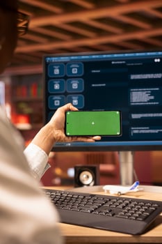 Woman using isolated screen mobile phone to look at tutorials about AI chatbots, closeup. Person holding chroma key smartphone to look at visual guides on artificial intelligence LLMs photo
