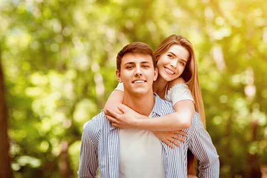 Romantic hug. Pretty girl embracing her boyfriend at green park photo
