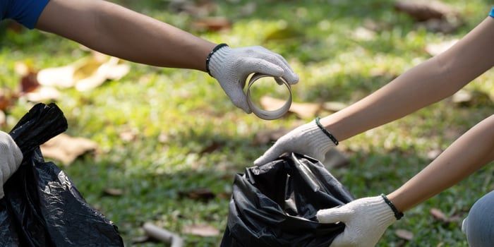 Community Engagement and Volunteer Efforts. Volunteers work together to collect trash for a cleaner environment, showcasing team spirit and cooperation. photo