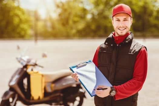 Delivery Services. Courier Guy Offering To Sign Papers Delivering Food And Documents On Moto Scooter In City. Free Space photo