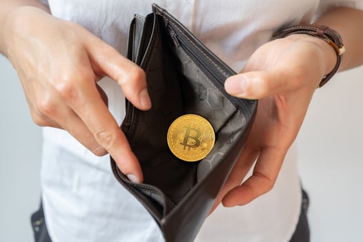 Close up of someone open wallet for showing just one Bitcoin token inside. photo
