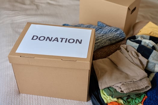 Clothes prepared for donation in cardboard box, Donation Box at home photo