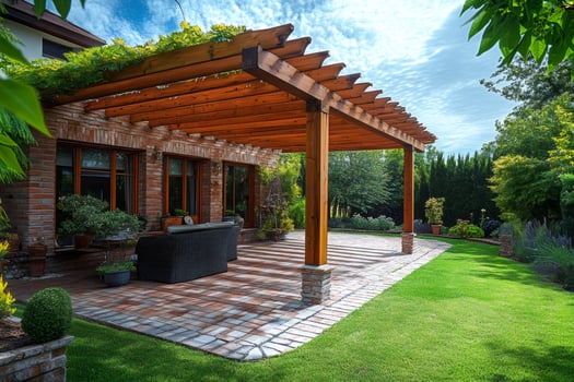 Wooden pergola providing shade on a brick patio in a lush backyard photo
