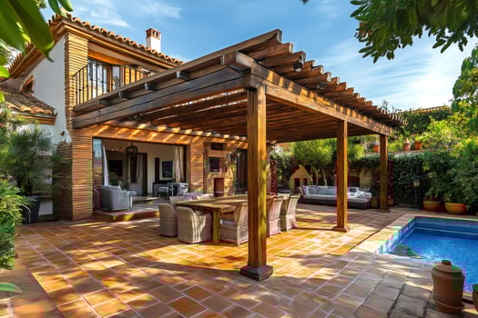 Wooden pergola providing shade on a patio with pool and brick house photo