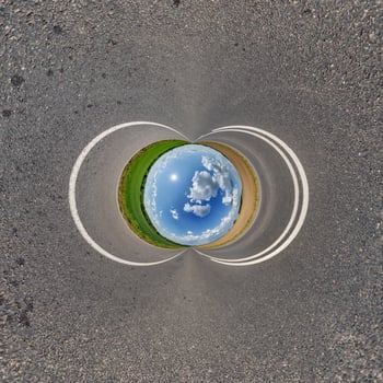 A circular road with a blue sky and white clouds photo