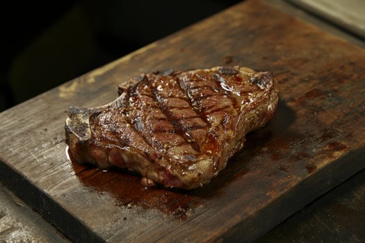 Grilled Steak on a Wooden Board Creating a Delicious Food Concept photo