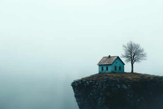Isolated blue house on fog-covered cliff photo