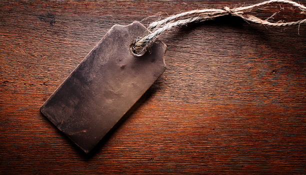 Rustic Tag Resting on a Wooden Surface With a Textured Finish During Afternoon Light photo