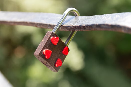 Padlock on a bridge depicting hearts photo
