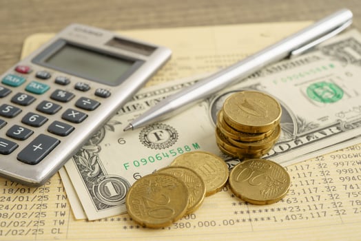 Coins money with calculator and pen on bookbank finance. photo