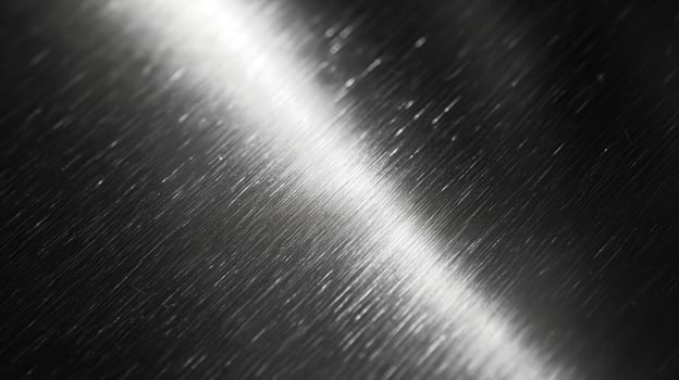 Close-up of a sleek, brushed metallic surface with subtle light reflections creating an elegant, modern aesthetic. photo