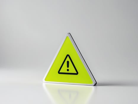 A yellow warning sign with a black exclamation mark photo