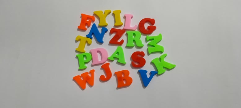 Colorful Plastic Alphabet Letters on White Background photo