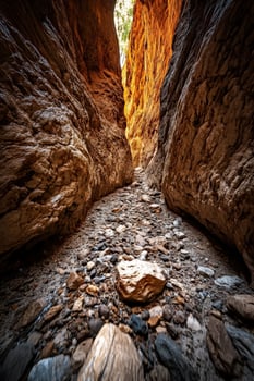 A narrow canyon with rocks and dirt photo