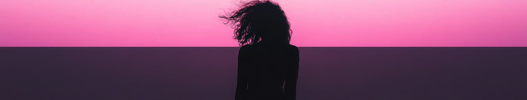 A black woman standing in front of a pink background photo