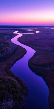 A river runs through a marsh at sunset photo